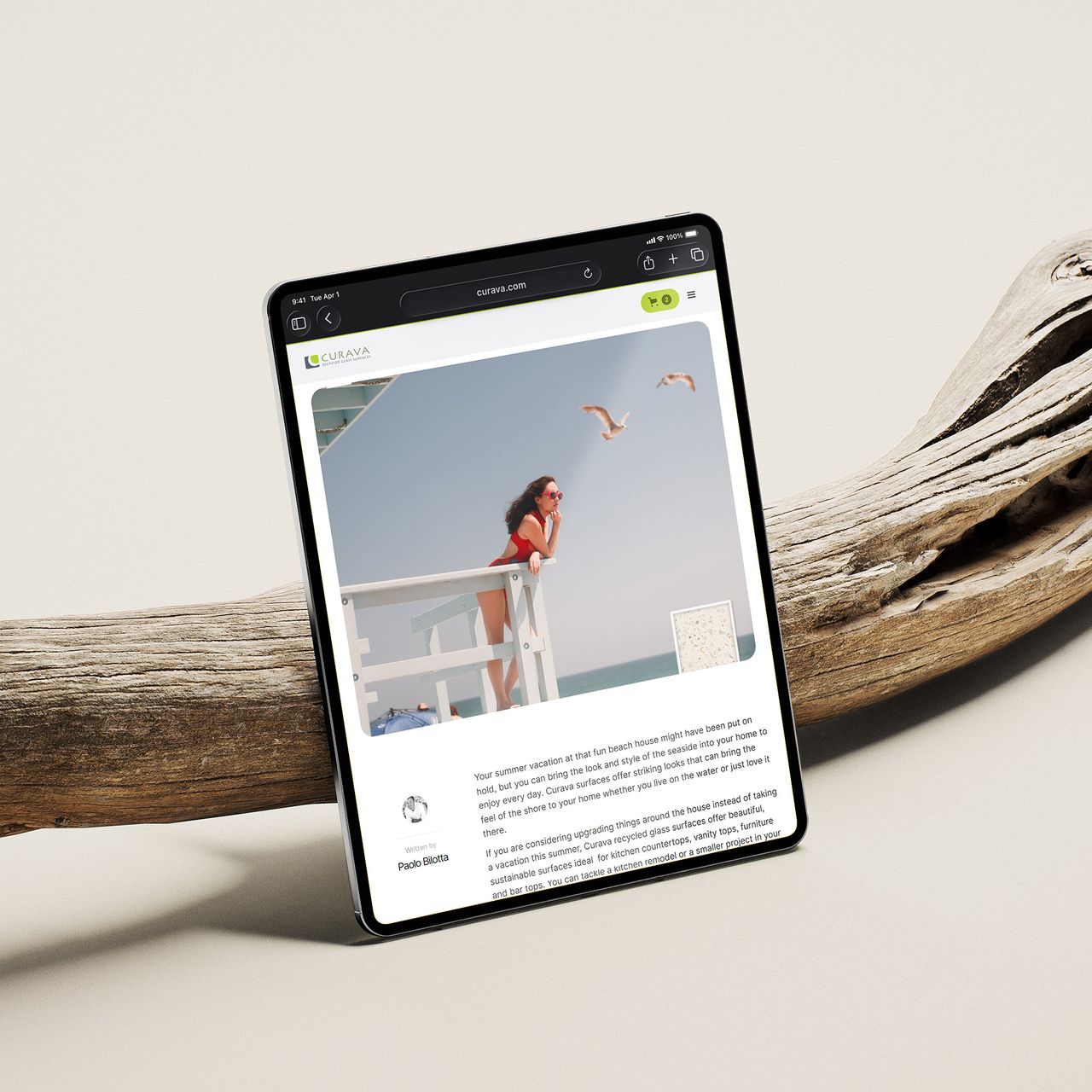 Tablet on driftwood showing a Curava article written by Paolo Bilotta