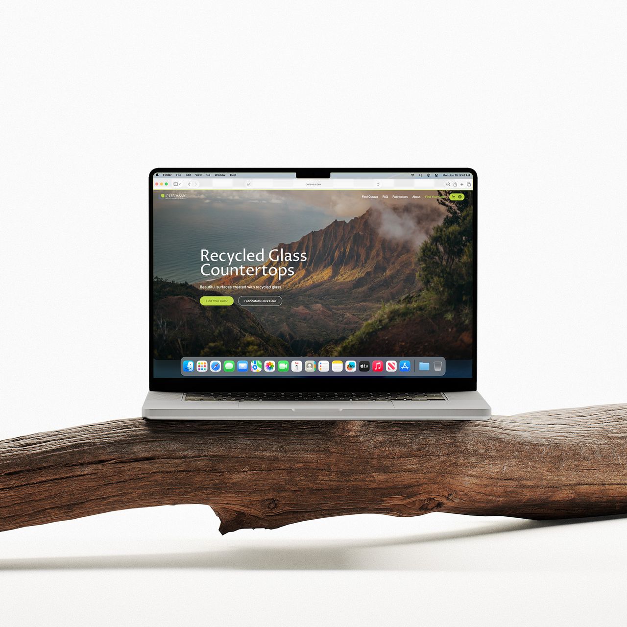 Laptop on driftwood showing the Curava homepage, Recycled Glass Countertops