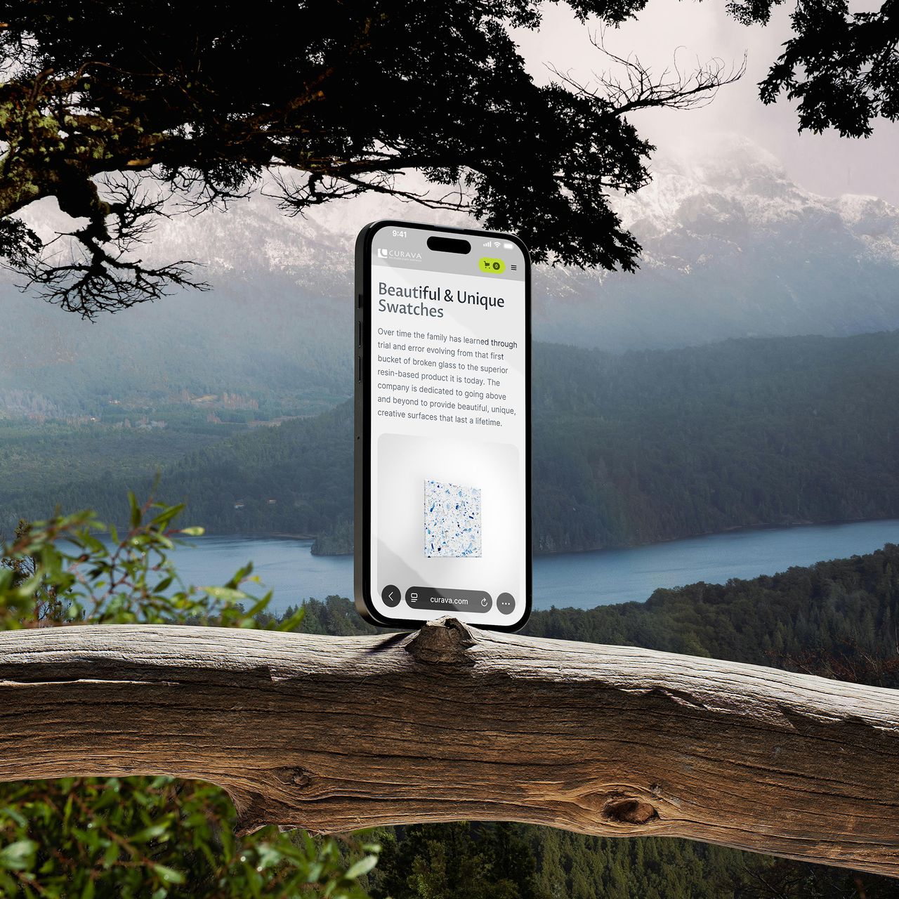 Phone on a branch showing Curava’s Beautiful and Unique Swatches page, with mountains behind it